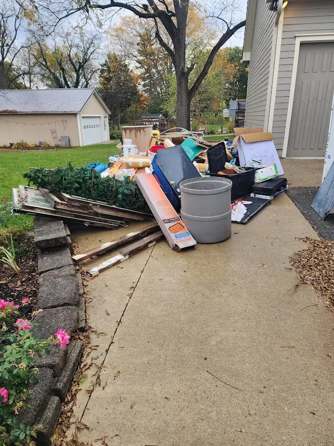 Dumpster being loaded with debris for Commercial Dumpster Rental in Shelter Island